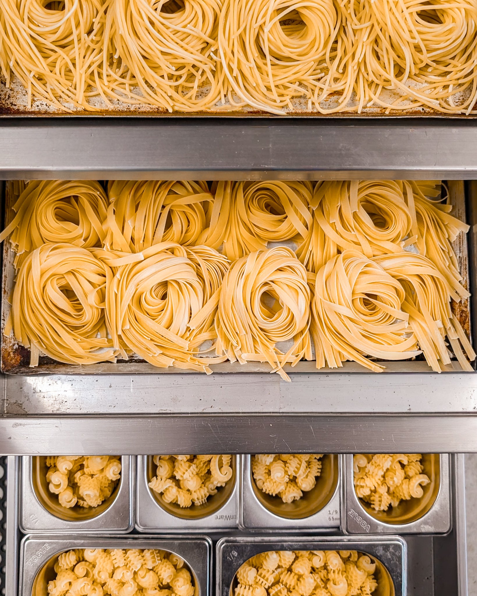 Collection of various types of pasta in a kitchen setting